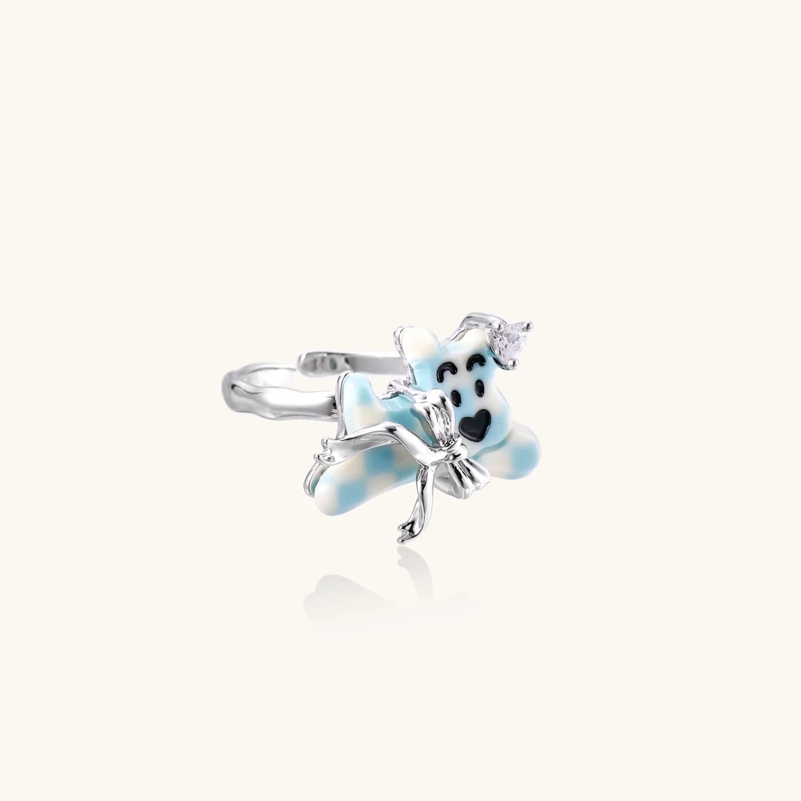 Adjustable white gold-plated ring with 3D blue enamel puppy wearing crystal crown on beige background