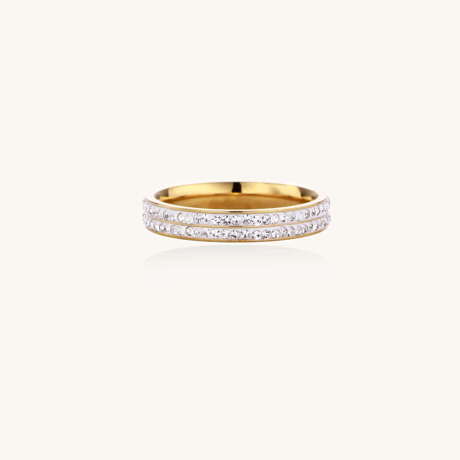 Gold-plated ring with two rows of clear rhinestones on white background