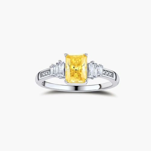 Sterling silver ring with emerald-cut yellow moissanite center stone and clear baguette side stones in elegant setting