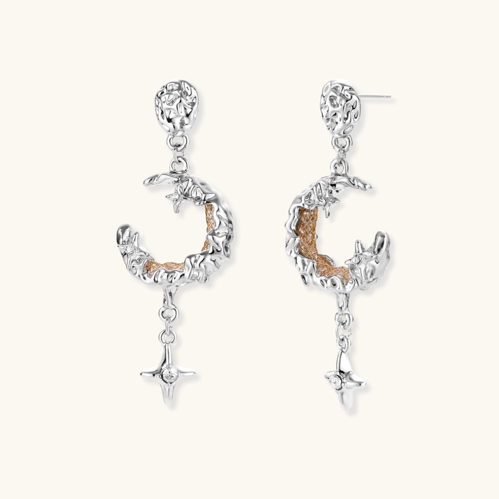 Detailed eco-brass dangle earrings featuring crescent moons with gold rope details and dangling star charms on white background.