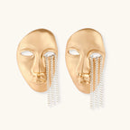 Sculptural face-shaped earrings with flowing chain tassels in polished eco-zinc alloy with sterling silver posts