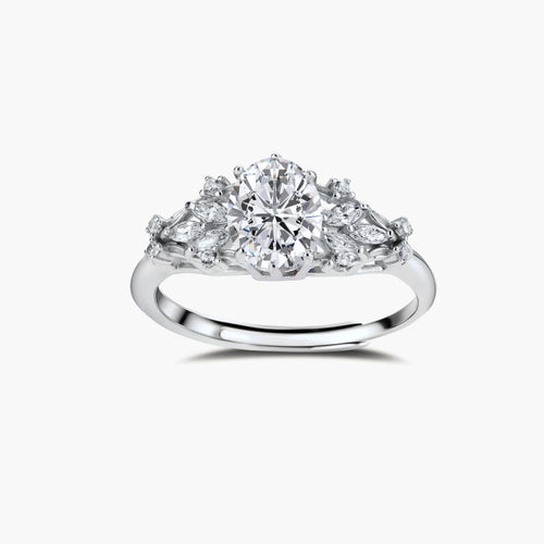 Sterling silver ring with oval moissanite center stone surrounded by smaller accent stones in ornate setting