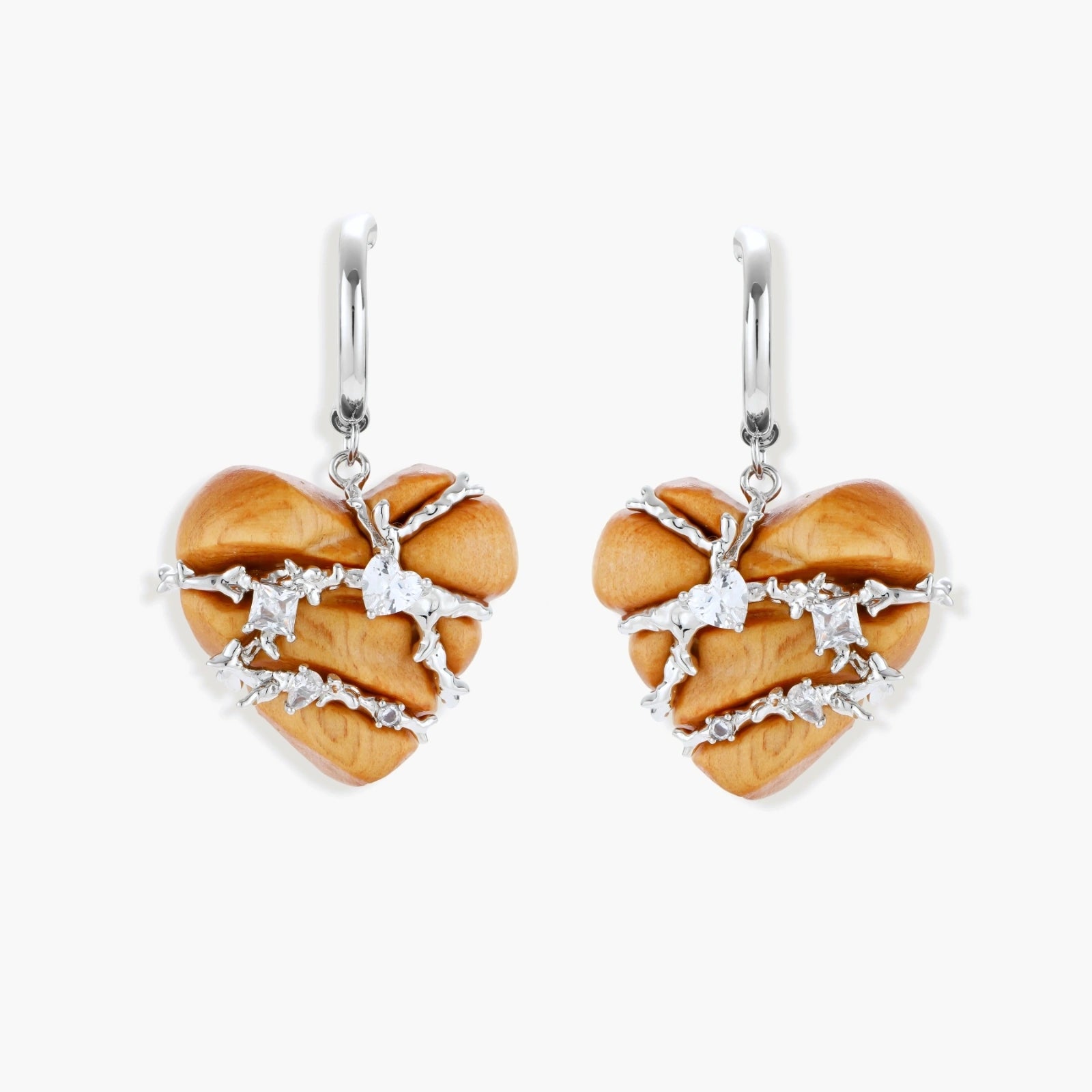 Heart-shaped wood earrings wrapped in silver wire with zirconia crystals, featuring ball stud posts on white background.