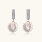 Rhodium-plated silver curved stud with pave stones and baroque pearl drop on white background