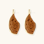 Textured brown resin drop earrings with gold-toned zinc alloy frames and sterling silver posts on white background.