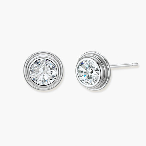 Close-up of sterling silver stud earrings featuring concentric circular frames with brilliant moissanite centers