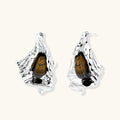 Silver sculptural earrings with flowing molten forms and amber gemstones, featuring 925 silver posts on white background.