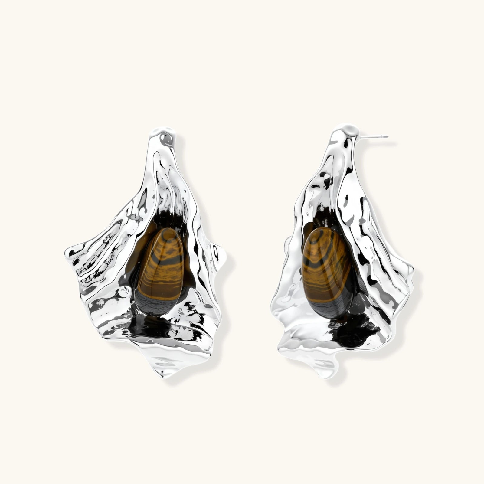 Silver sculptural earrings with flowing molten forms and amber gemstones, featuring 925 silver posts on white background.