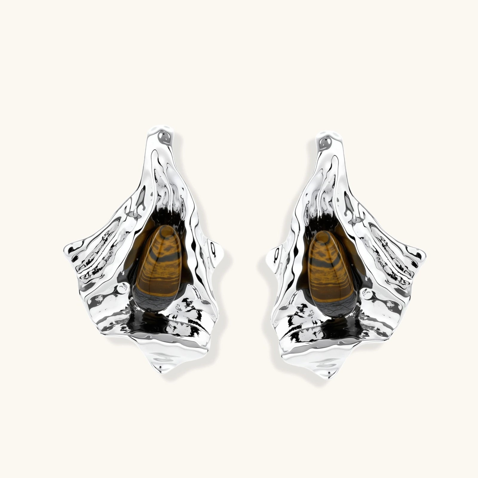 Silver sculptural earrings with flowing molten forms and amber gemstones, featuring 925 silver posts on white background.