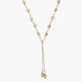 Adjustable gold lariat necklace with freshwater pearls nested in delicate cage settings and Y-shaped tassel drop