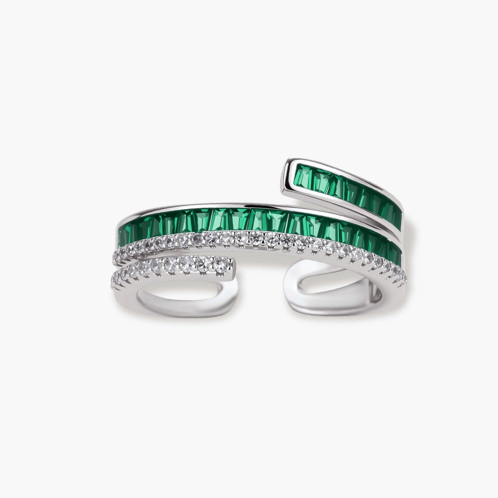 Modern adjustable ring with green baguette stones and clear crystals in parallel bands on white background.
