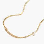 Gold-plated necklace with geometric diamond segments and matching huggie earrings featuring cubic zirconia details