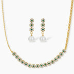 Gold-plated jewelry set with green cubic zirconia floral motifs, featuring matching necklace and pearl drop earrings