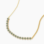 Gold-plated jewelry set with green cubic zirconia floral motifs, featuring matching necklace and pearl drop earrings
